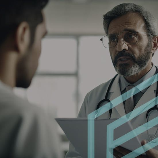 A doctor with glasses and a white coat, holding a clipboard, converses with a patient. The scene appears to be in a medical office, with blurred windows in the background. The doctor looks concerned as he listens attentively.